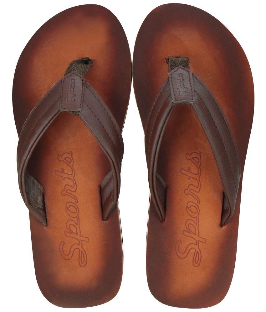 tan flip flops with black straps